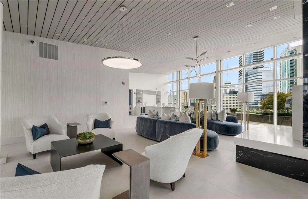 Common area featuring expansive windows, wooden ceiling, and a view of city