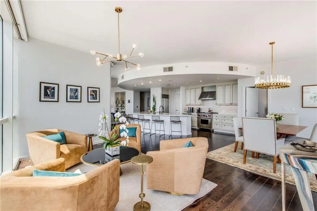 Living area featuring a chandelier, dark wood-type flooring, and recessed lighting