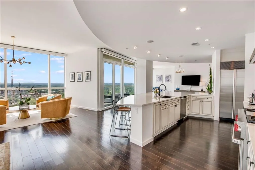 Kitchen with a chandelier, hanging light fixtures, open floor plan, high quality appliances, and a peninsula