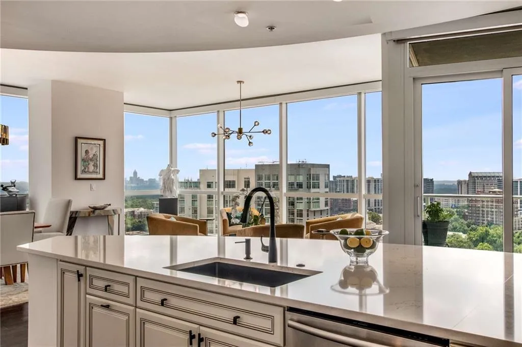 Kitchen featuring open floor plan, a chandelier, expansive windows, plenty of natural light, and pendant lighting