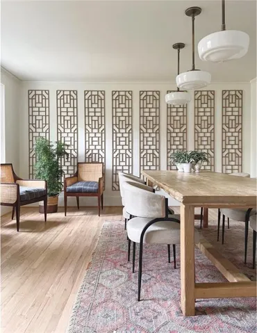 Hardwood flooring, decorative wall panels, three pendant light fixtures, and a natural wood-finish table