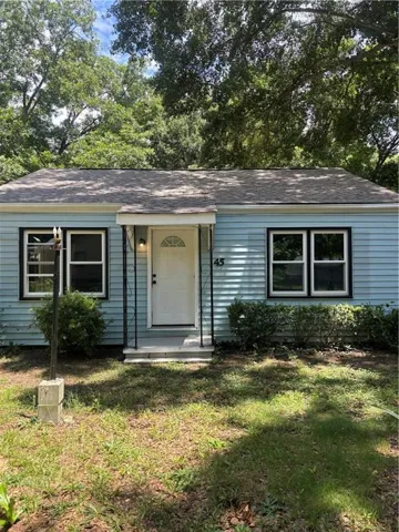 Light blue siding exterior with dark trim windows