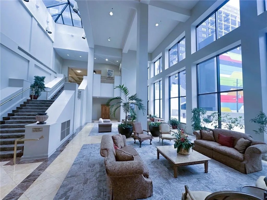 Common area featuring a towering ceiling, stairs, and recessed lighting