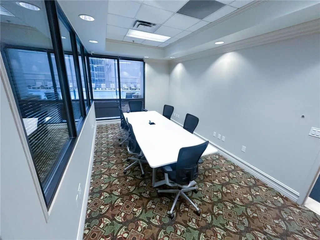 Office space featuring a raised ceiling, crown molding, a drop ceiling, recessed lighting, and dark carpet