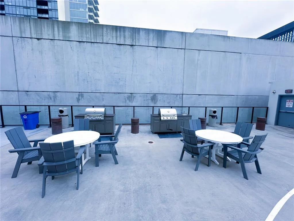 View of patio / terrace featuring outdoor dining space and a grill