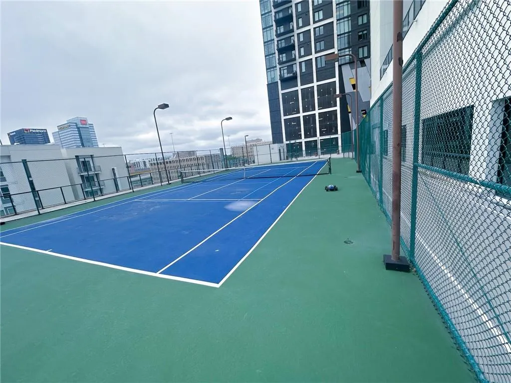 View of tennis court with a view of city