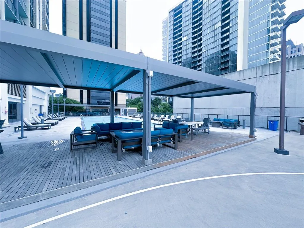 View of community with an outdoor hangout area, a view of city, and a deck
