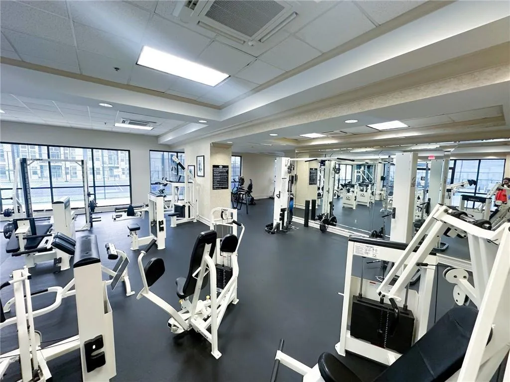 Exercise room featuring a drop ceiling and baseboards