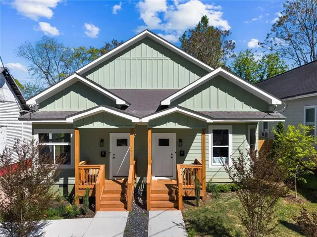 Duplex exterior with light green vertical and horizontal siding