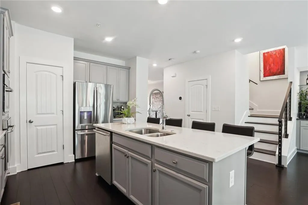 Kitchen with gray cabinets, dark fossilized bamboo floors