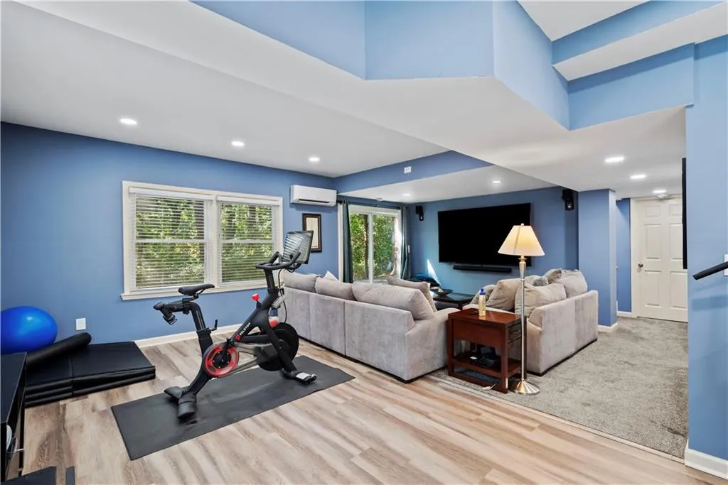 Exercise room with recessed lighting and wood finished floors