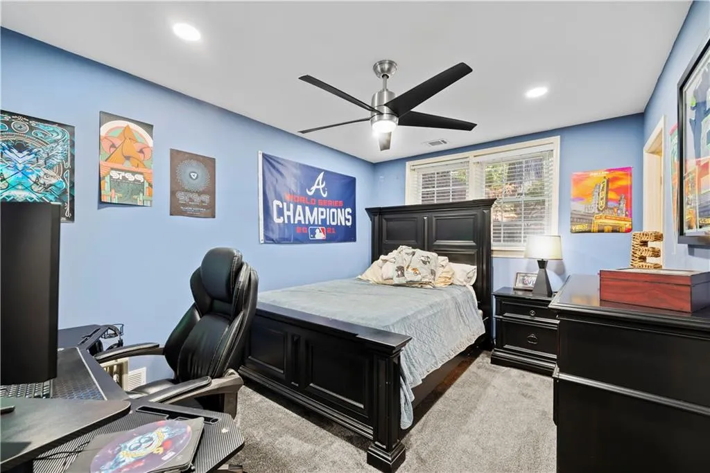 Bedroom with a desk, a ceiling fan, recessed lighting, and light carpet