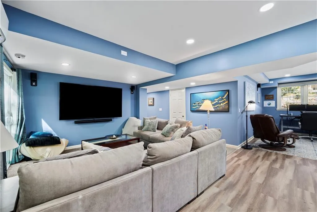 Home theater room featuring recessed lighting and wood finished floors
