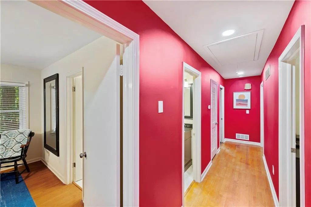 Hallway featuring light wood-type flooring and attic access