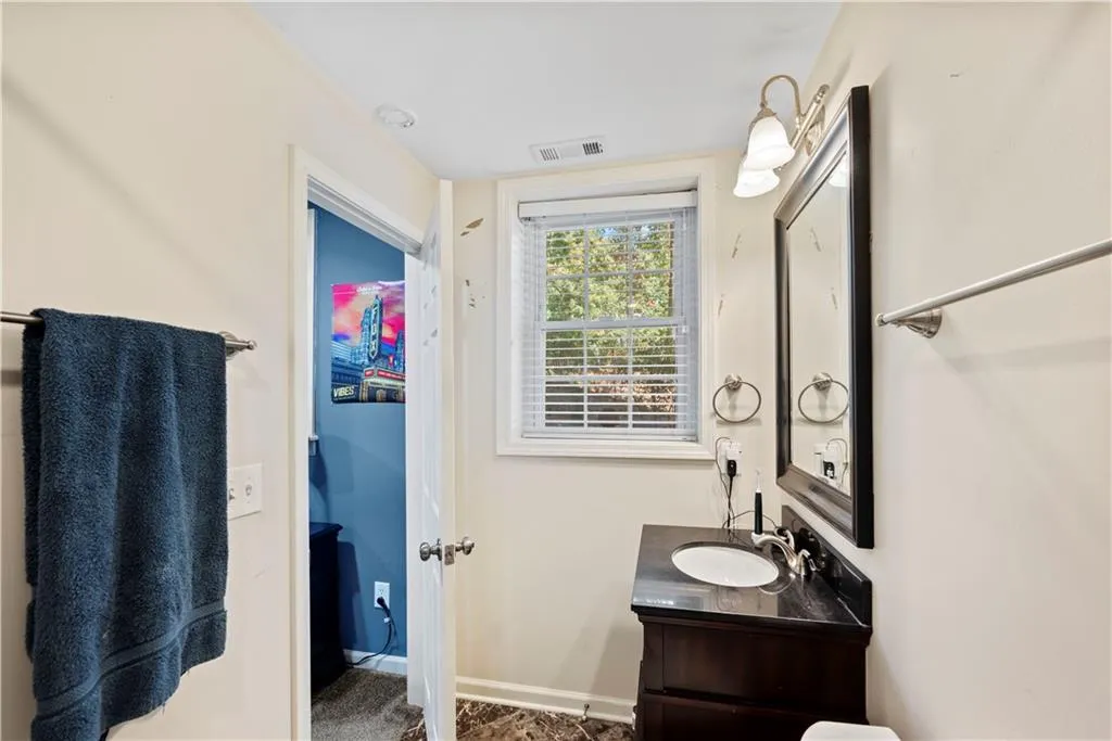 Bathroom featuring vanity and baseboards