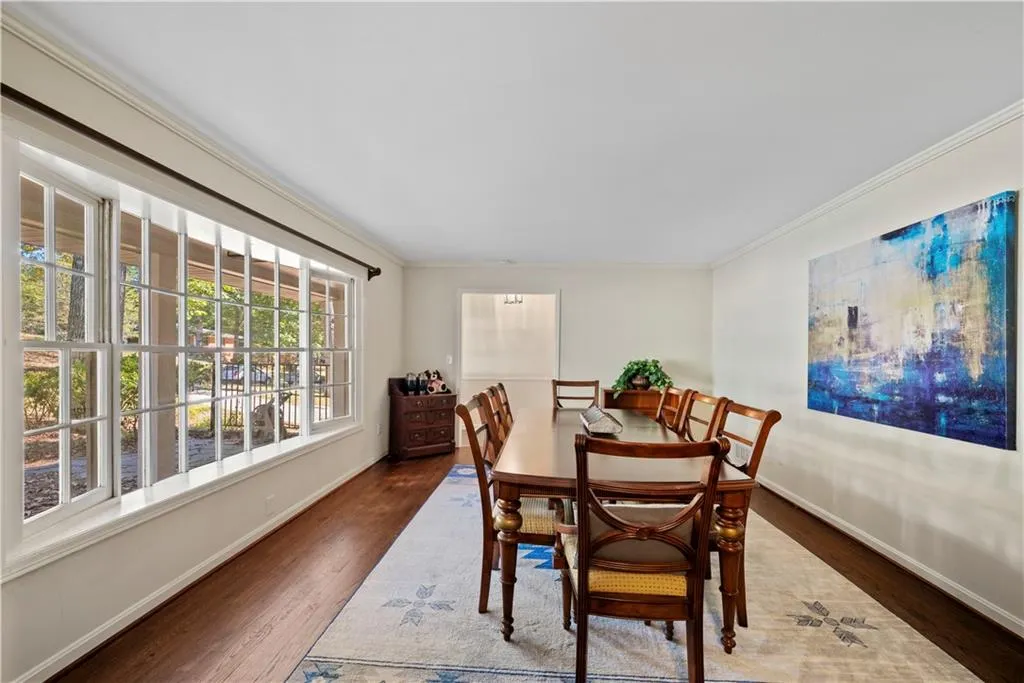 Dining room featuring wood finished floors and crown molding