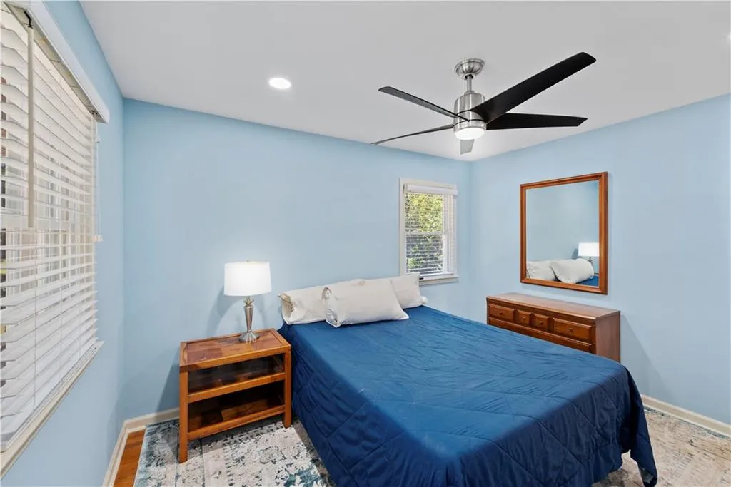 Bedroom with ceiling fan and recessed lighting