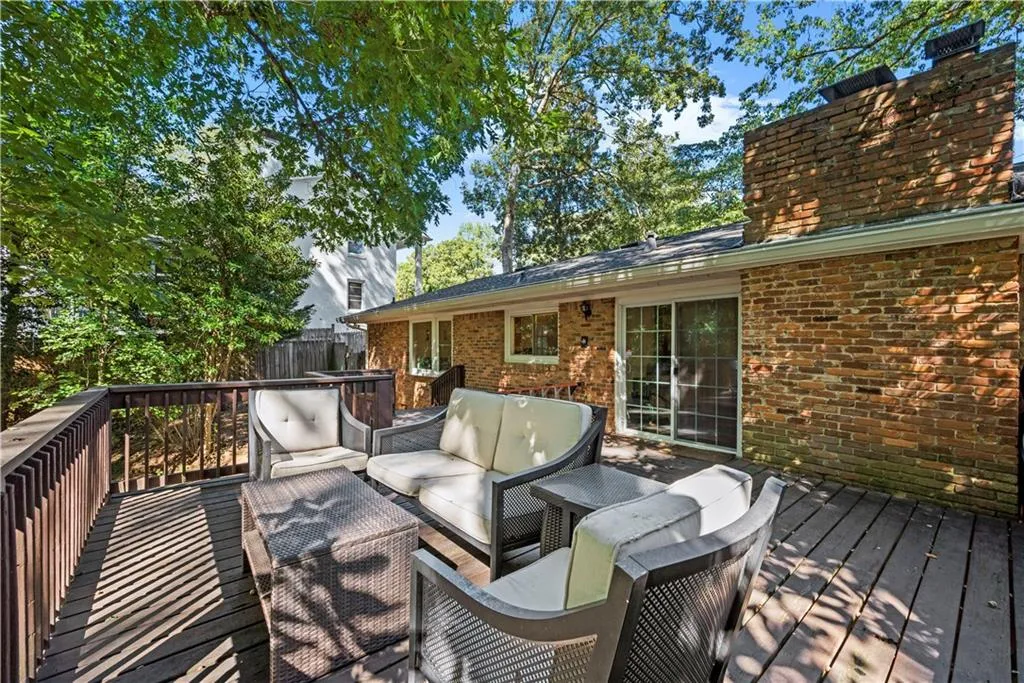 Wooden deck with an outdoor hangout area and grilling area
