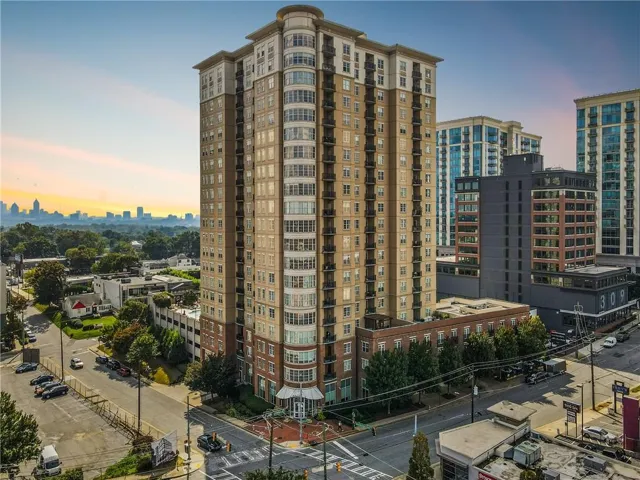 High-rise building with extensive window lines, multiple balconies, and a distinctive rounded architectural element