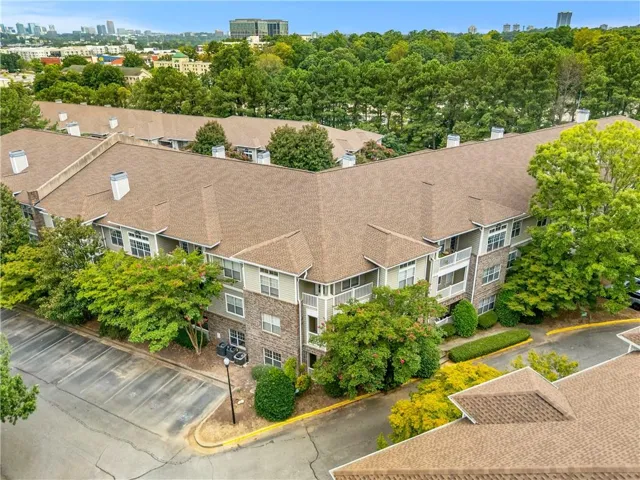 Multi-story building featuring a blend of brick and siding exteriors, balconies, and dormer windows