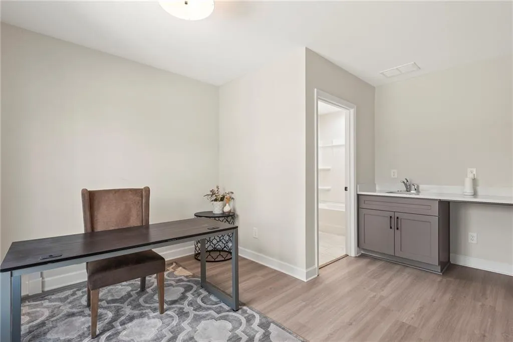 Office space with light wood-style floors and baseboards