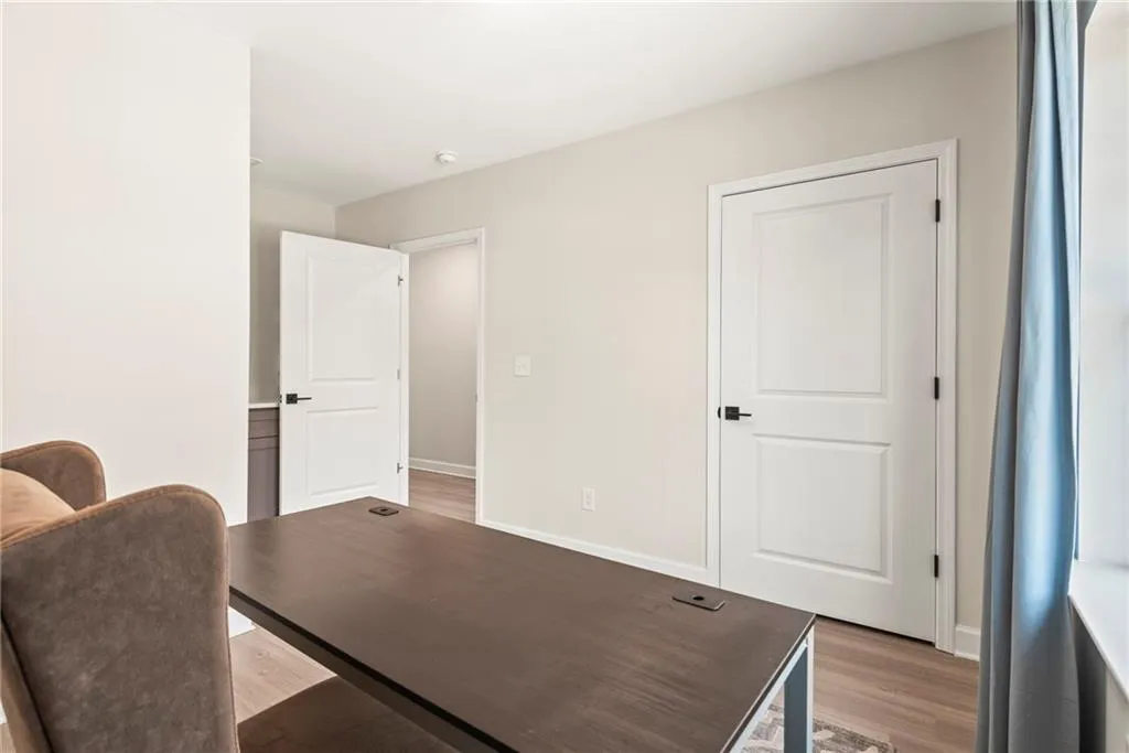 Office featuring baseboards and wood finished floors