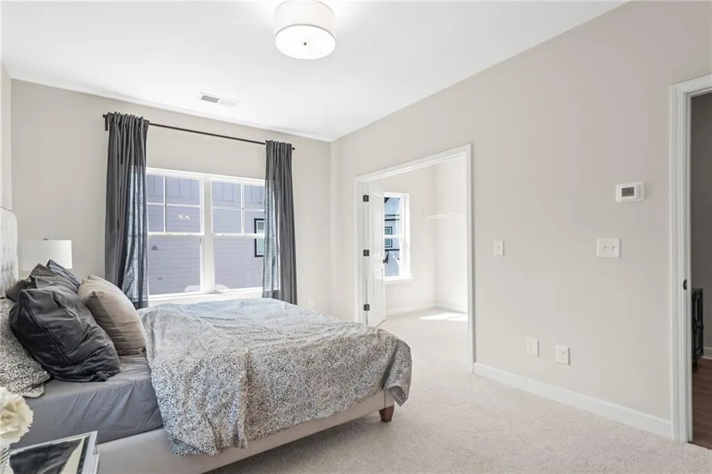 Carpeted bedroom featuring baseboards
