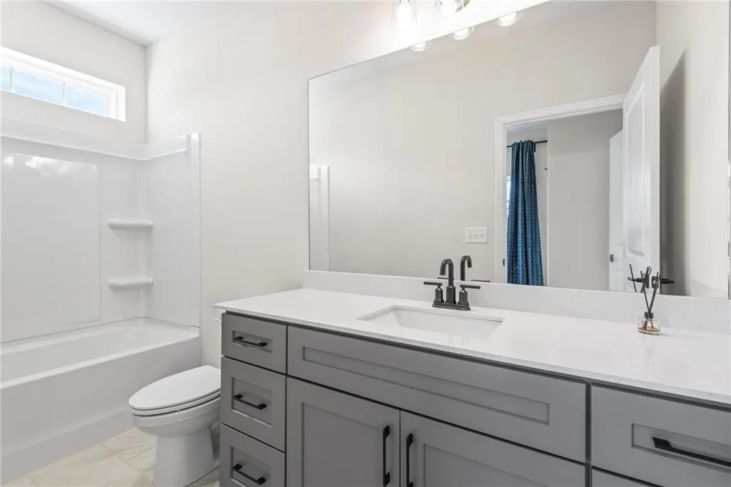 Full bathroom featuring vanity and shower / bathtub combination with curtain