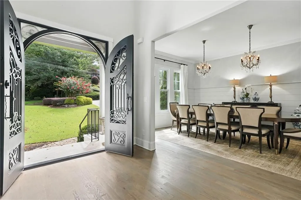 Foyer featuring wood finished floors, ornamental molding, and a chandelier