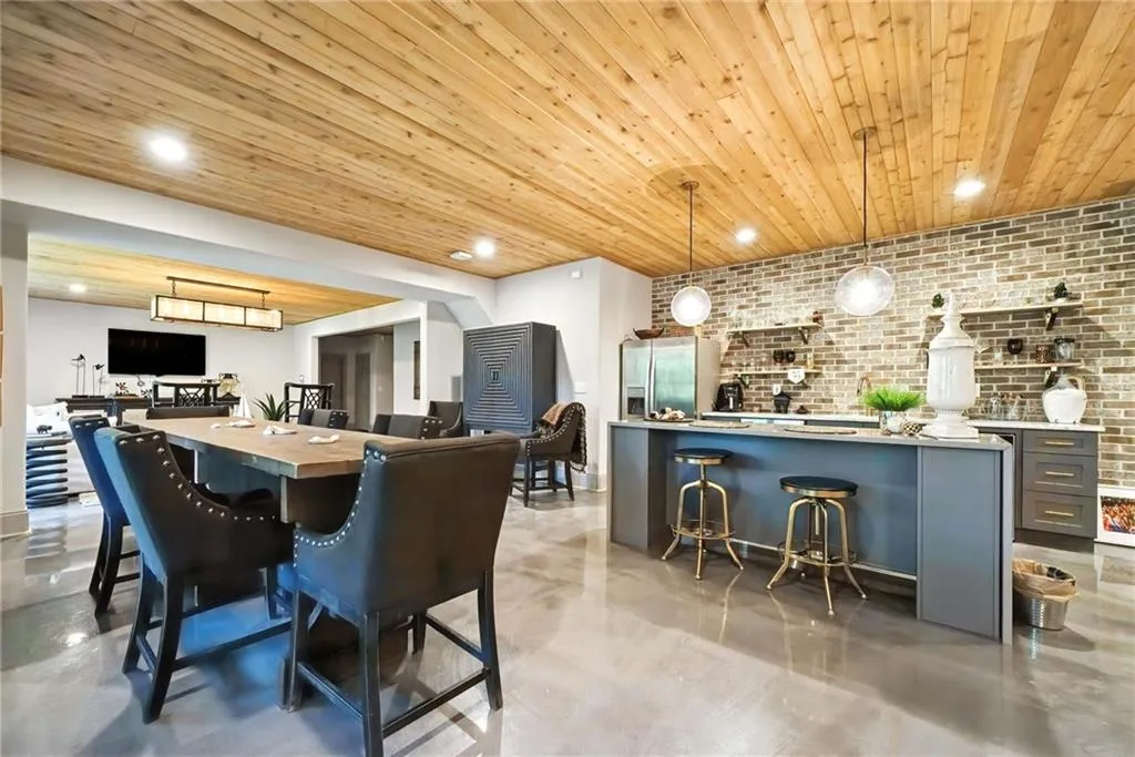 Dining area featuring brick wall, recessed lighting, finished concrete floors, and wood ceiling