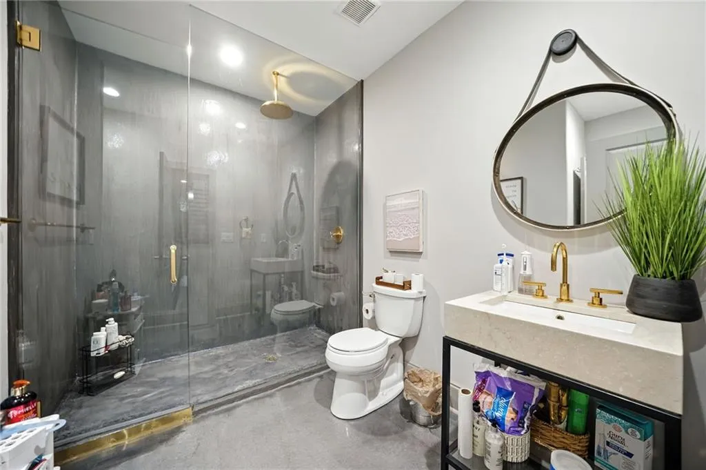 Bathroom with a shower stall and vanity