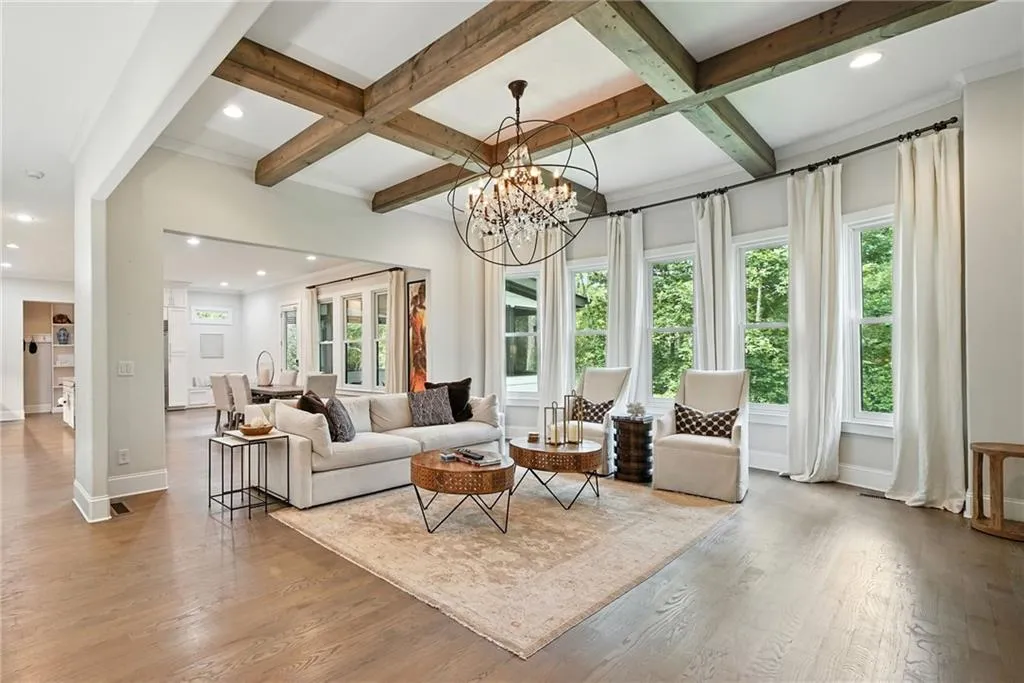Living area featuring beam ceiling, recessed lighting, light wood-type flooring, a chandelier, and coffered ceiling