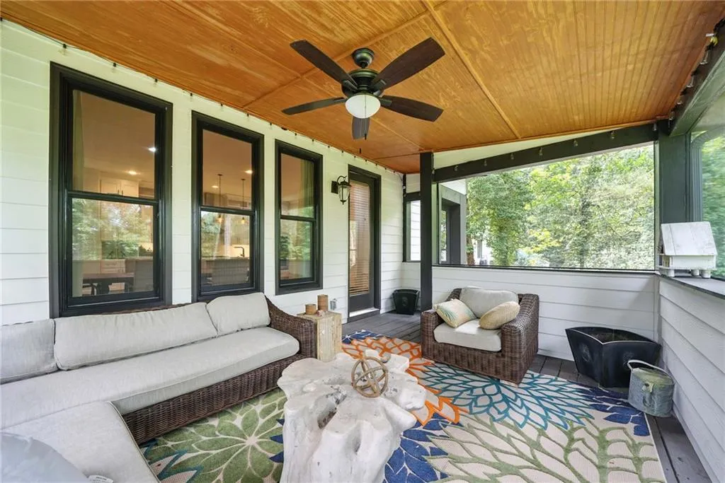 Sunroom / solarium featuring a ceiling fan and an outdoor living space