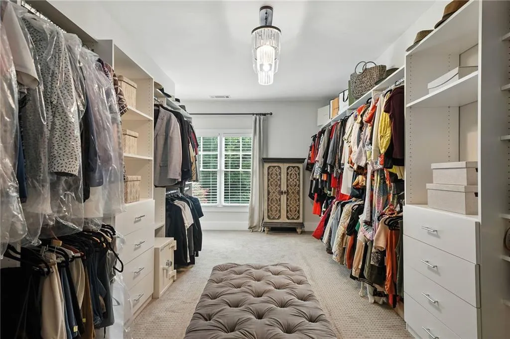Spacious closet with light colored carpet