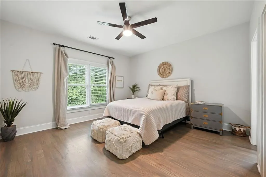 Bedroom featuring wood finished floors and a ceiling fan
