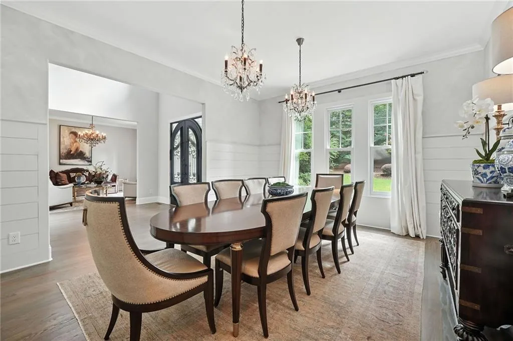 Dining room featuring a chandelier, crown molding, and light wood-style flooring