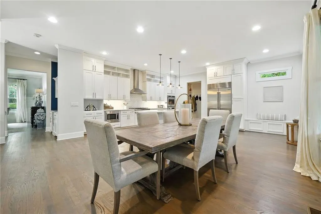 Dining space with crown molding, dark wood-style flooring, and recessed lighting