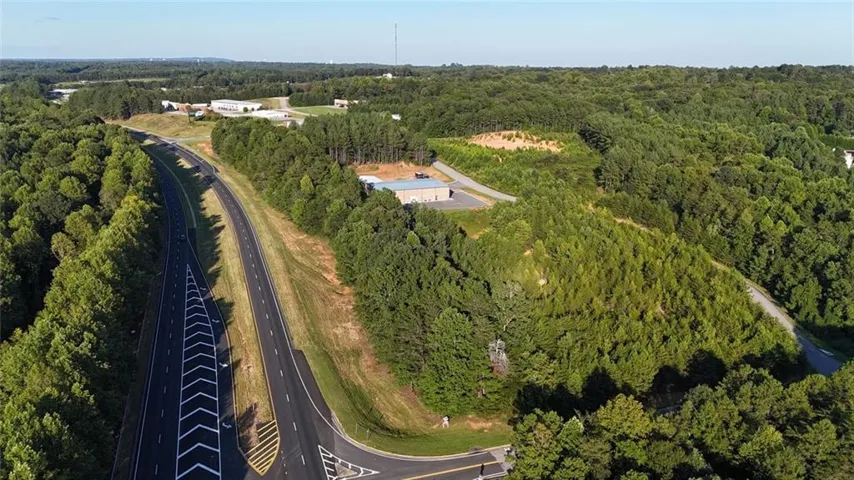 Aerial view of property's location with a forest