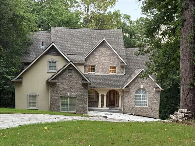 Two-story residence featuring a combination of brick and stucco exterior finishes