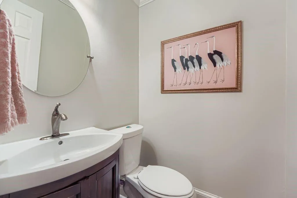 Half bath featuring vanity and toilet Half bath featuring vanity and toilet