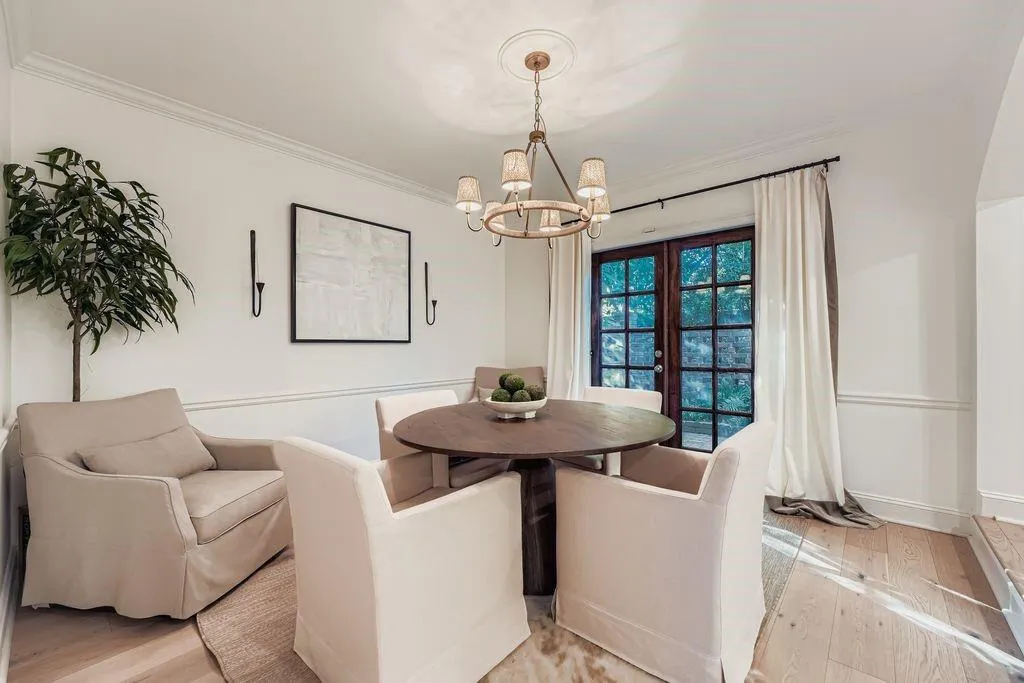 Dining area with hardwoods, crown molding, french doors, and a chandelier Dining area with hardwoods, crown molding, french doors, and a chandelier