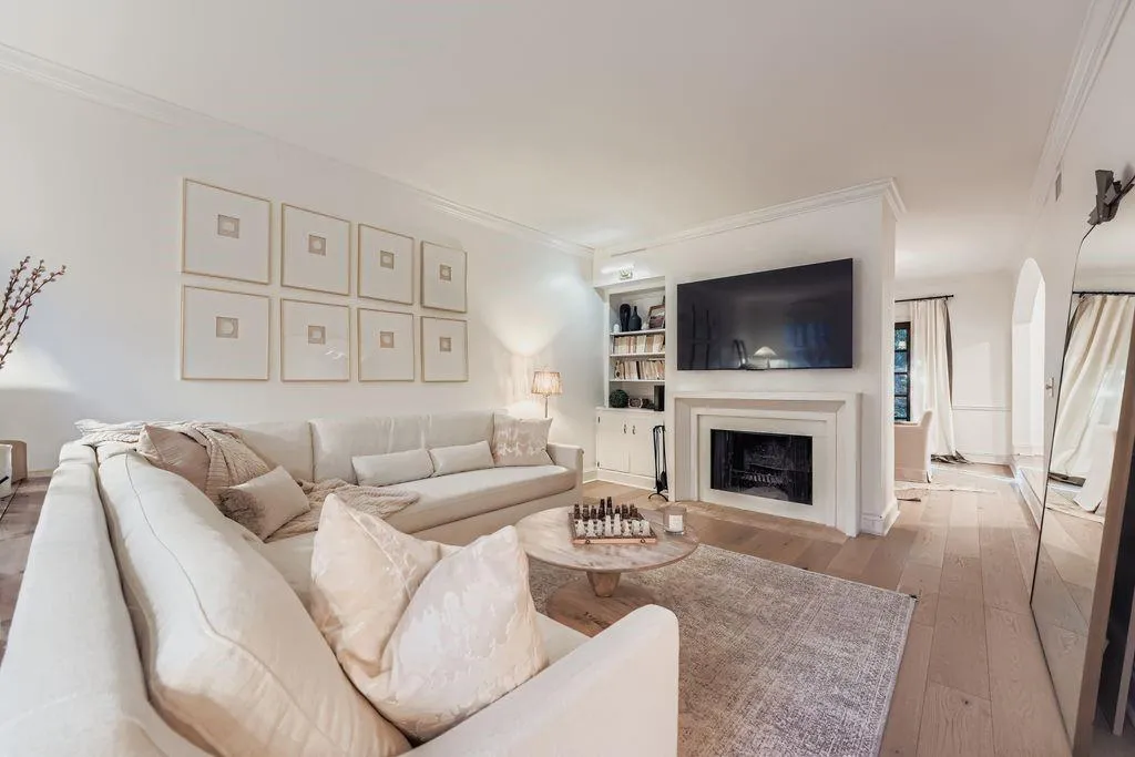 Living area with crown molding, hardwood, a wood burning fireplace with flush hearth, and arched doorways - simply stunning Living area with crown molding, hardwood, a wood burning fireplace with flush hearth, and arched doorways - simply stunning