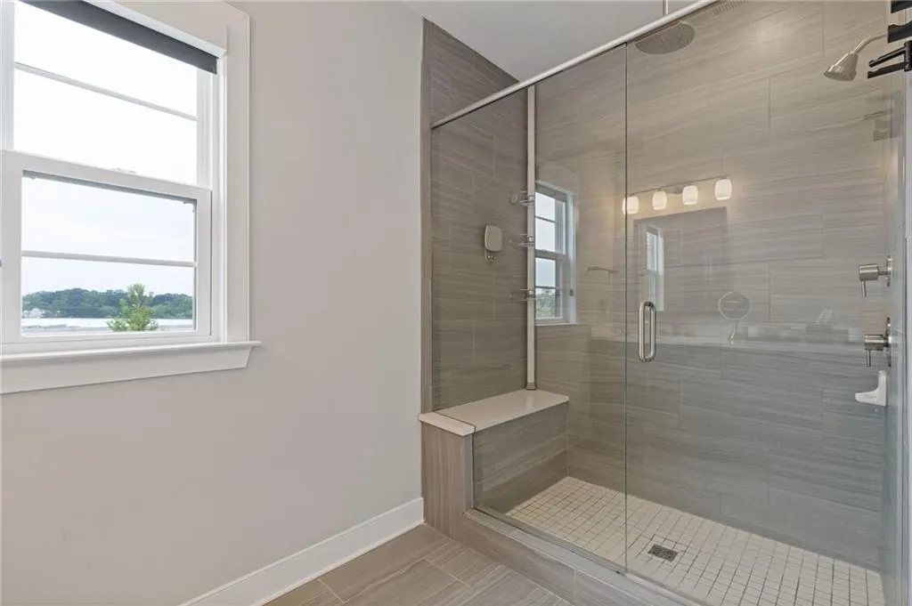 Bathroom featuring baseboards and a shower stall