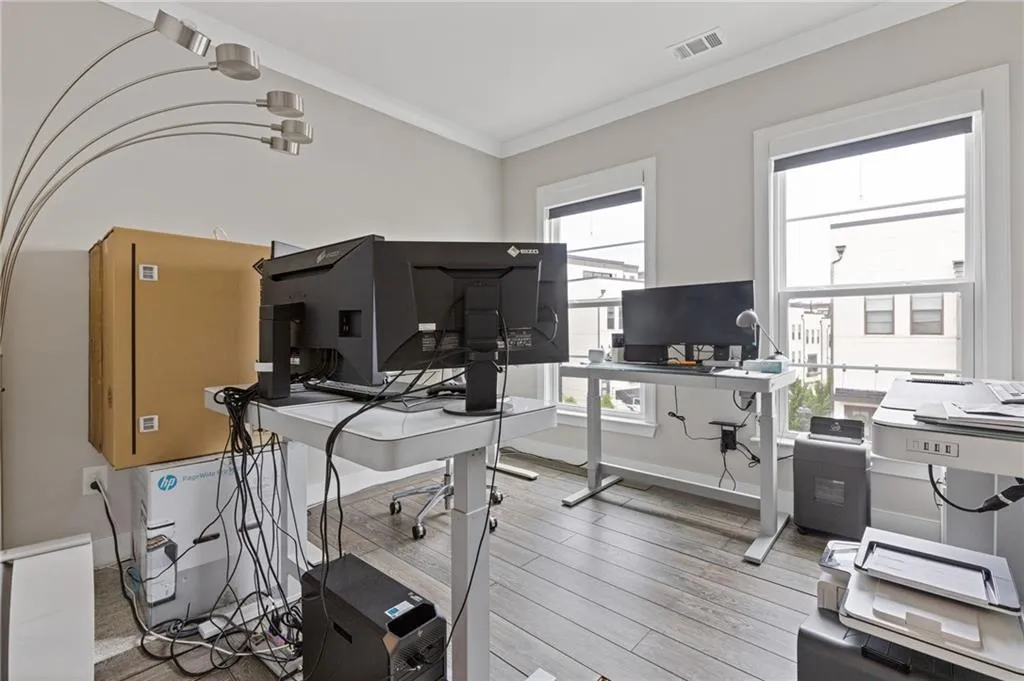 Office area featuring ornamental molding and light wood-style flooring