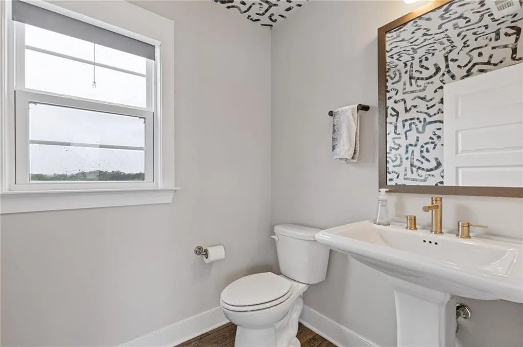 Bathroom featuring baseboards and dark wood-type flooring