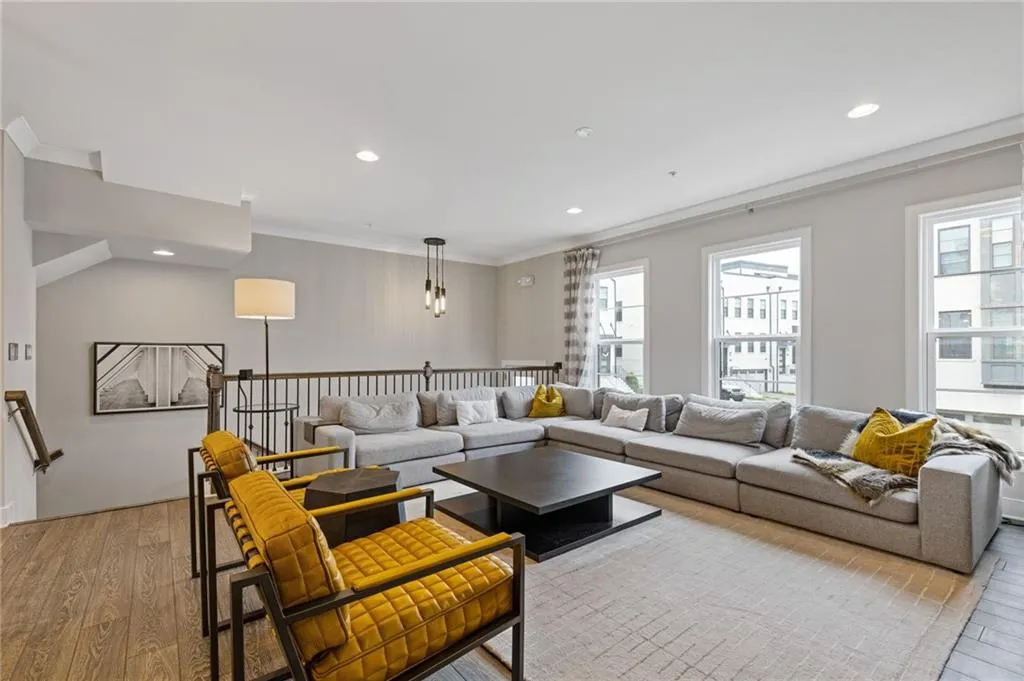 Living room featuring hardwood / wood-style flooring, crown molding, and recessed lighting