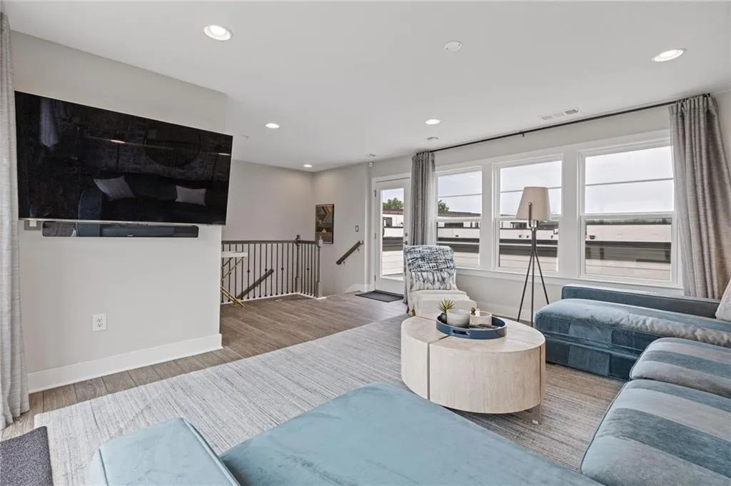 Living area with wood finished floors and recessed lighting