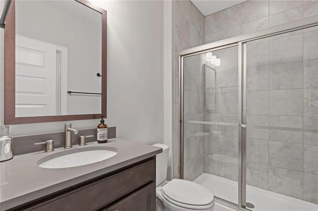 Full bath with vanity and a stall shower