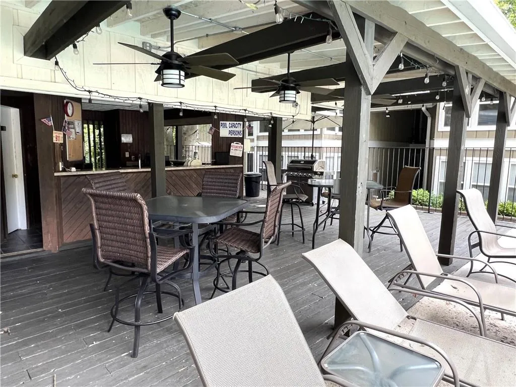 Wooden deck with ceiling fan at Pool