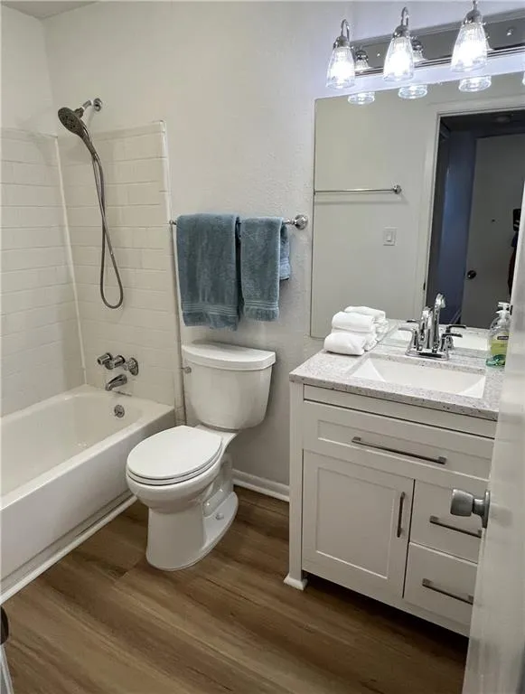 Full bathroom with newer vanity and lighting